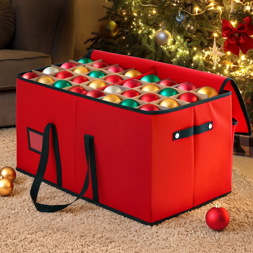Translation missing: en.Christmas bauble storage box with compartments holding ornaments beside lit Christmas tree: Christmas Storage Solutions