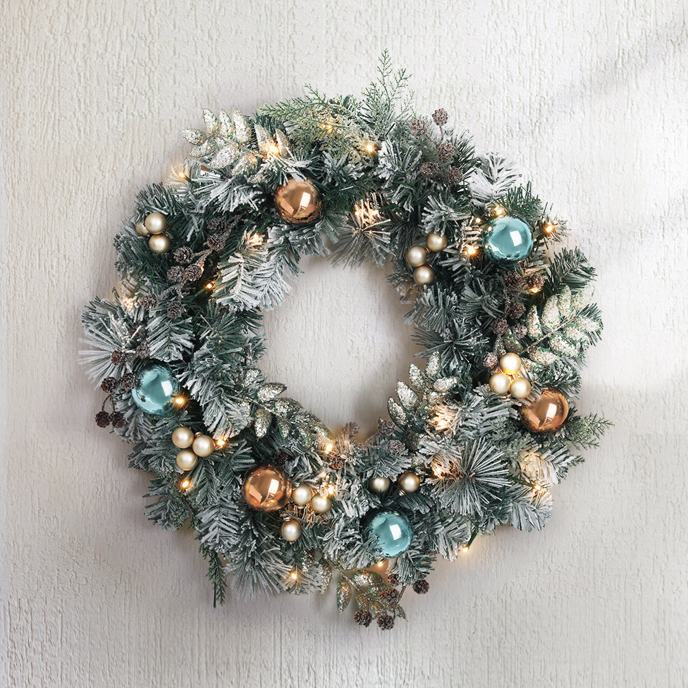 Translation missing: en.Frosted Christmas wreath with warm white LED lights and gold and teal baubles mounted on a wall: Wreaths
